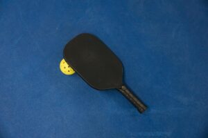 pickleball paddle on blue background